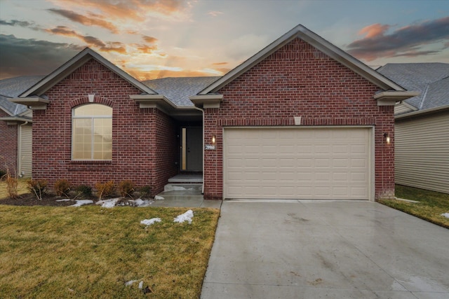 ranch-style house featuring a front yard, concrete driveway, brick siding, and an attached garage