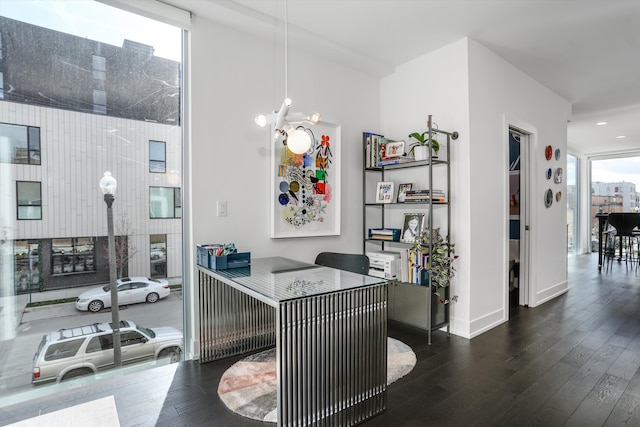 office space featuring dark hardwood / wood-style flooring and an inviting chandelier