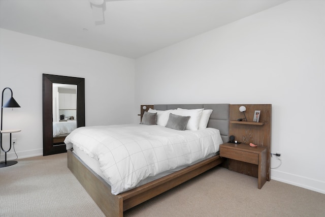 bedroom featuring ceiling fan and light carpet