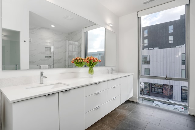 bathroom featuring vanity and a shower with shower door