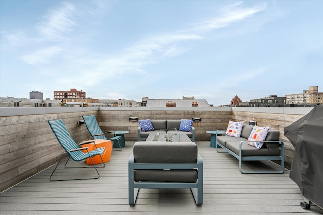 deck with grilling area and an outdoor living space