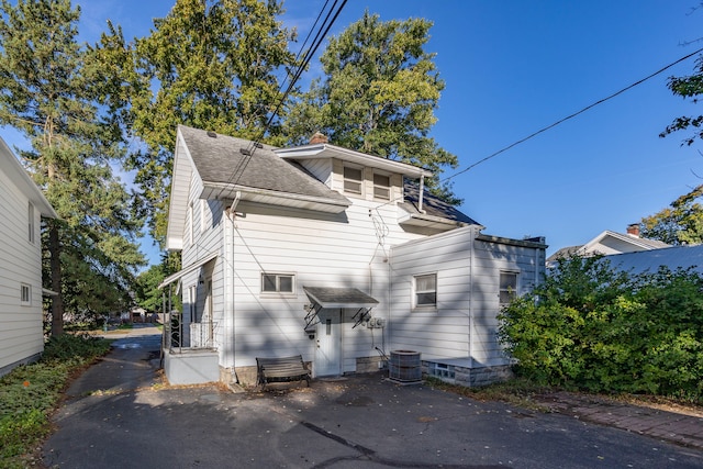 rear view of house with central AC unit