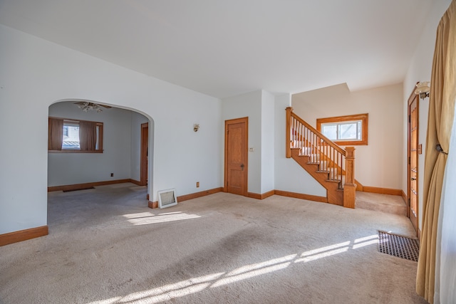 spare room featuring light carpet