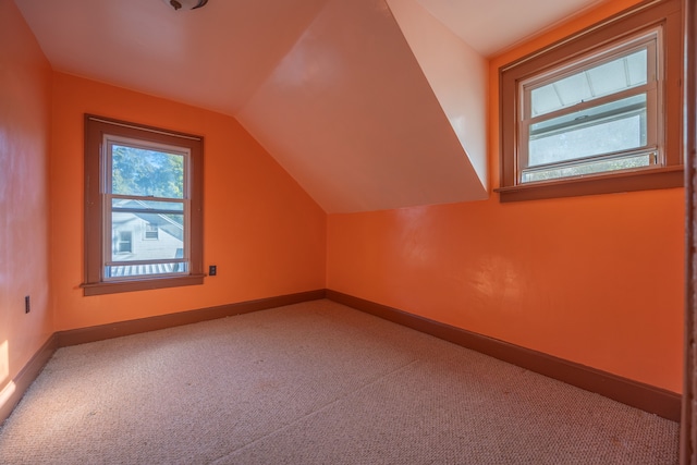 bonus room featuring carpet floors and vaulted ceiling