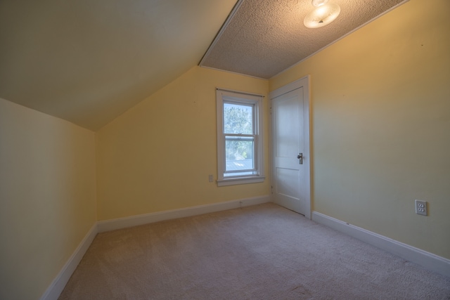 bonus room with a textured ceiling, carpet flooring, and lofted ceiling