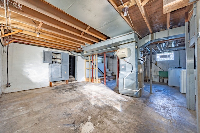 basement with washer / dryer and heating unit