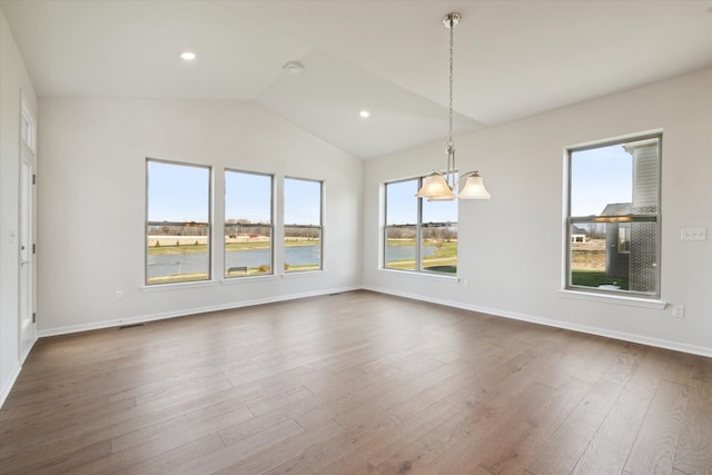 spare room with lofted ceiling, recessed lighting, baseboards, and dark wood-style flooring