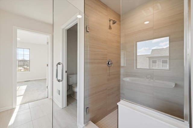 full bathroom with tile patterned flooring, a shower stall, toilet, and baseboards