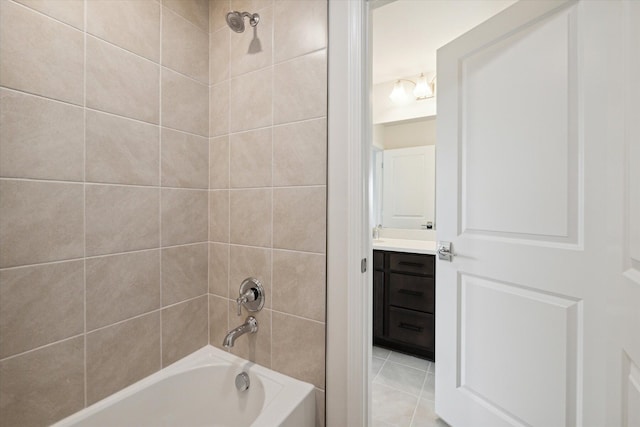 bathroom with tile patterned floors, washtub / shower combination, and vanity