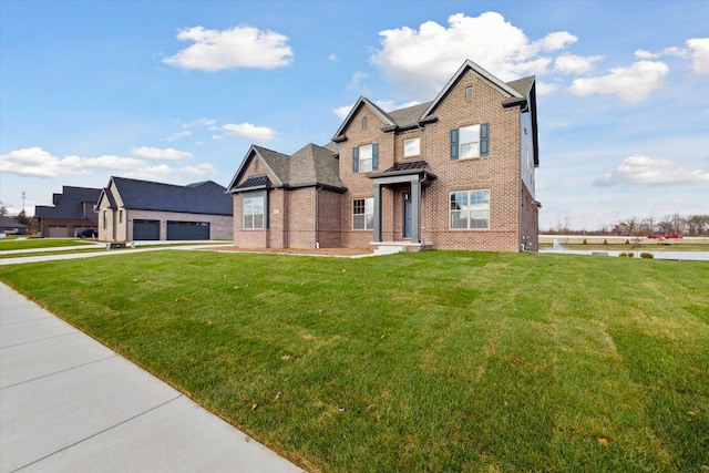 view of front facade featuring brick siding and a front yard