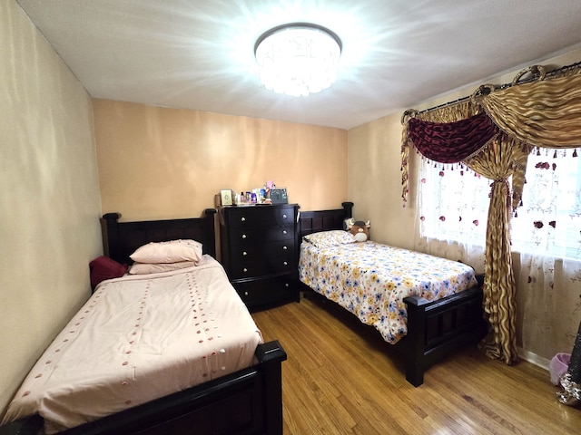 bedroom with wood-type flooring