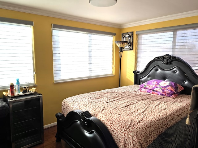 bedroom with dark wood-type flooring and crown molding