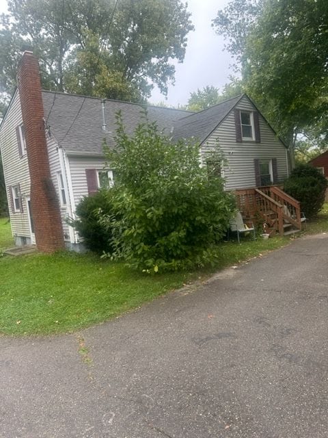 view of side of property featuring a yard