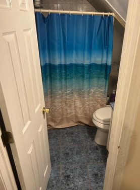 bathroom with toilet and walk in shower