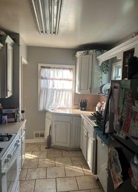 kitchen featuring white range with electric stovetop and white cabinetry