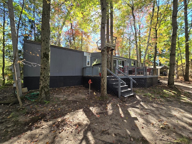 rear view of house with a wooden deck