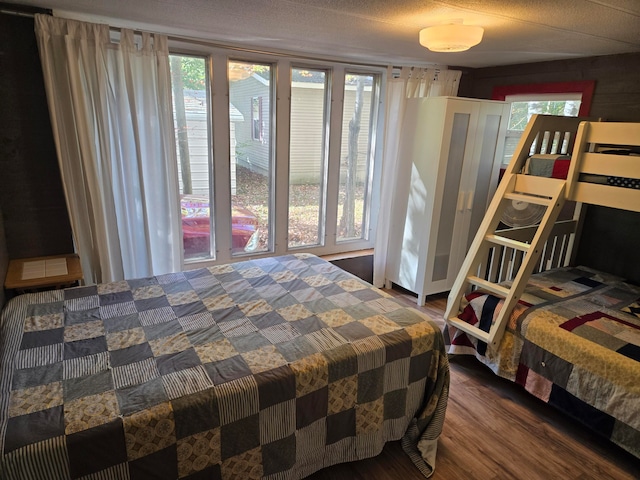 bedroom with hardwood / wood-style flooring and a textured ceiling