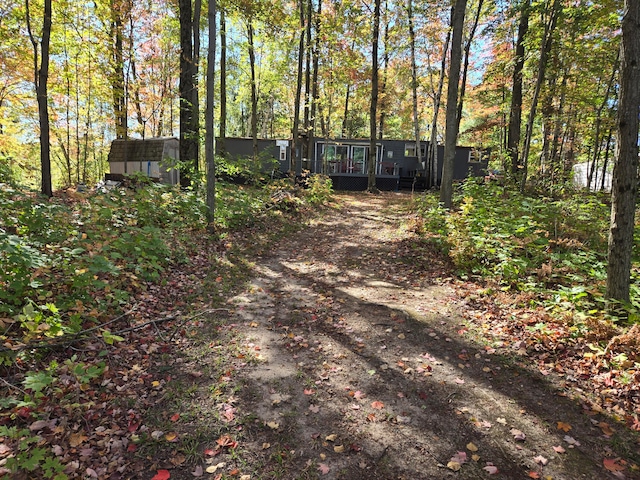 exterior space with a wooden deck and a storage unit