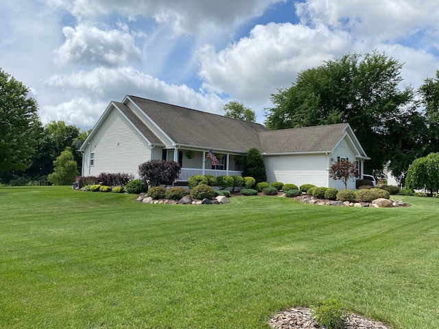 ranch-style home with covered porch and a front yard