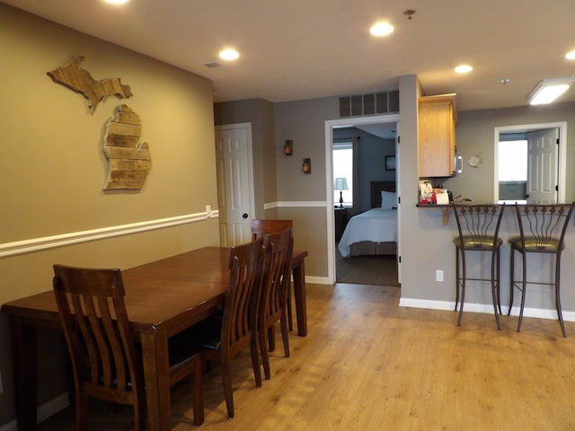 dining space with light hardwood / wood-style flooring