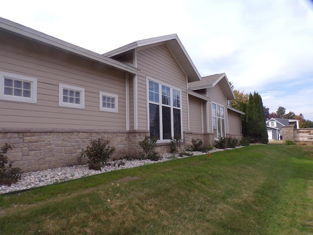 view of property exterior with a lawn