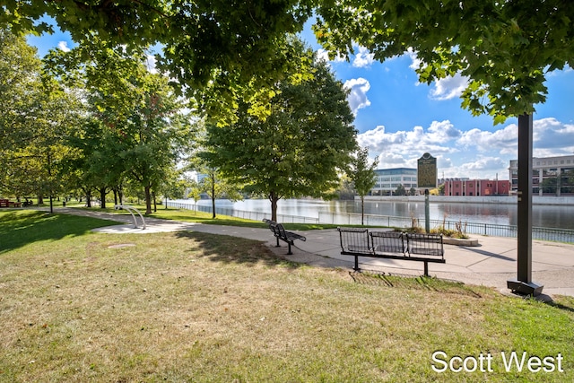 view of property's community with a yard and a water view