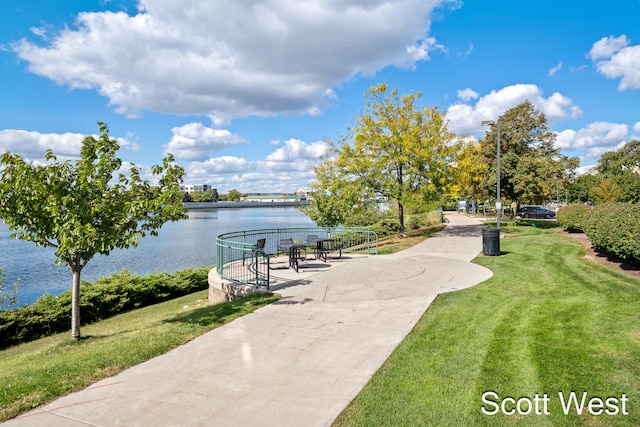 view of community featuring a lawn and a water view