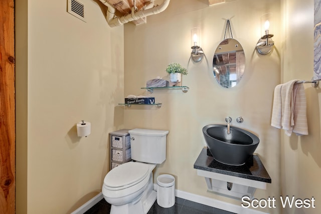 bathroom featuring tile patterned floors and toilet