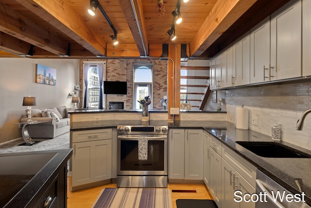 kitchen with wooden ceiling, track lighting, sink, appliances with stainless steel finishes, and light hardwood / wood-style floors