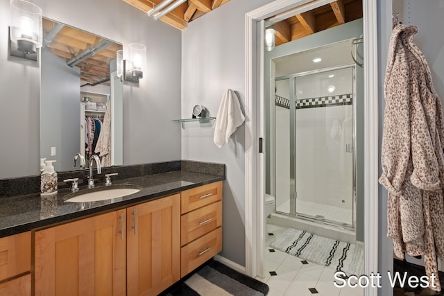 bathroom with tile patterned flooring, vanity, toilet, and an enclosed shower