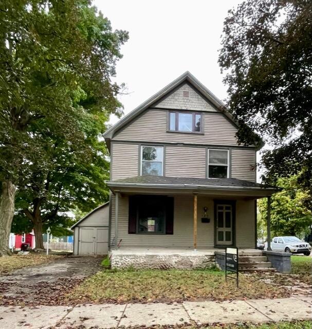 120 Oak St, Hillsdale, MI 49242 - view of front of house with covered porch and an outbuilding