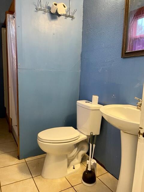 120 Oak St, Hillsdale, MI 49242 - half bathroom with toilet and tile patterned floors