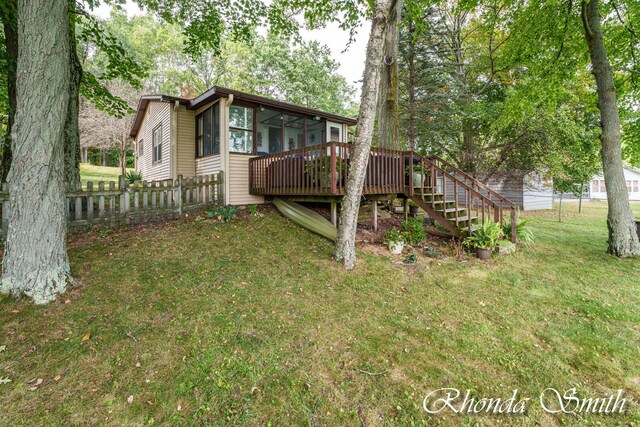11432 Lakeshore Dr, Lakeview, MI 48850 - back of property with a wooden deck, stairway, and a sunroom