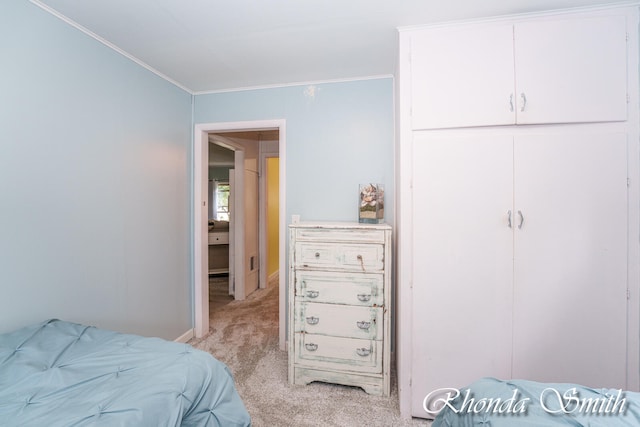 carpeted bedroom featuring crown molding
