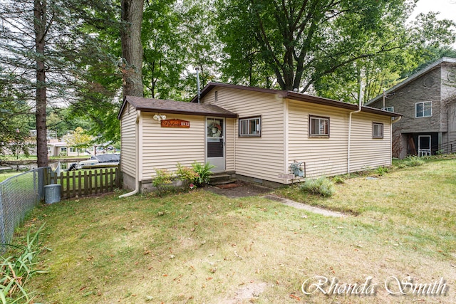 back of property with a lawn