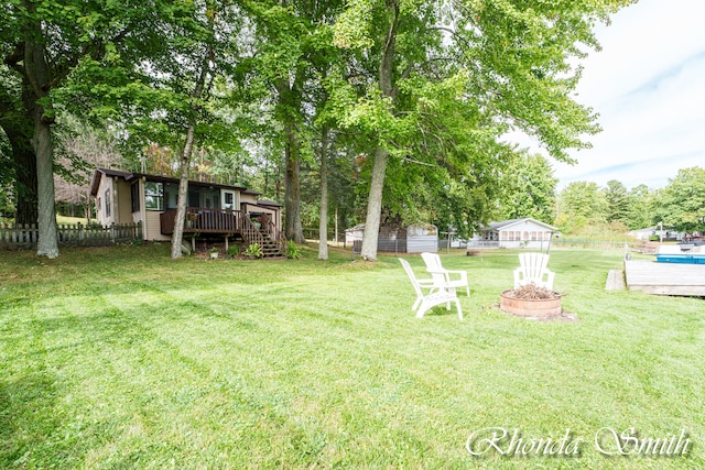 view of yard with a fire pit and a wooden deck