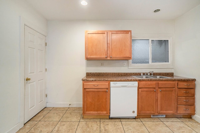 kitchen featuring sink, light tile patterned flooring, and white dishwasher