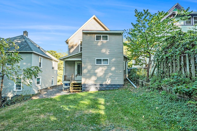 back of house featuring a yard