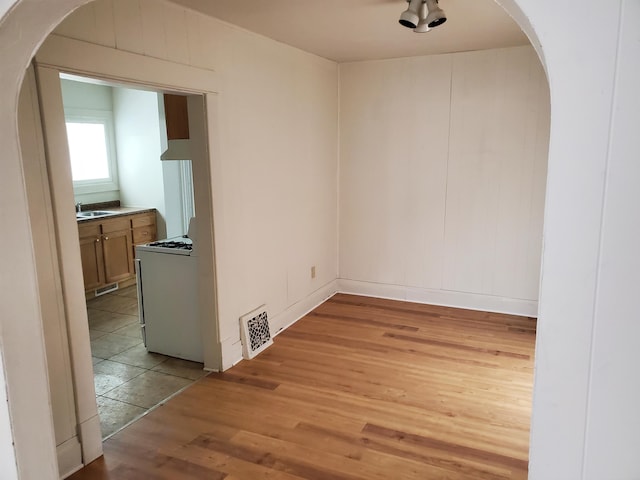 unfurnished dining area with light hardwood / wood-style flooring and sink