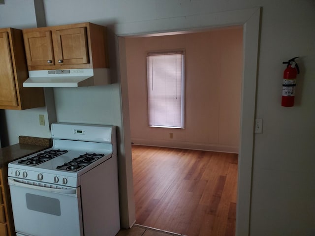 kitchen featuring light wood-type flooring and white range with gas cooktop