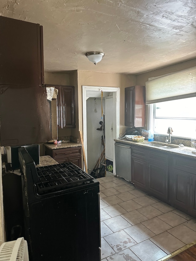 kitchen with dark brown cabinetry, dishwasher, a textured ceiling, and sink