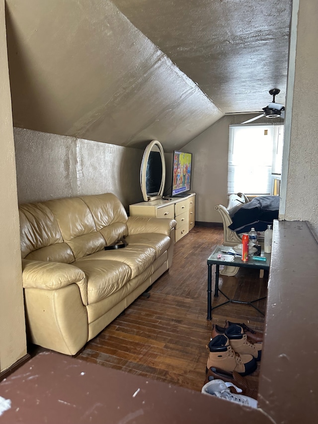 living room featuring hardwood / wood-style floors, ceiling fan, and lofted ceiling