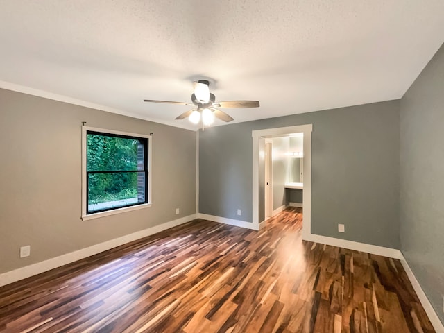 unfurnished room with ceiling fan, dark hardwood / wood-style flooring, and a textured ceiling