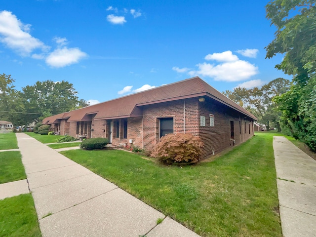 view of side of property with a yard