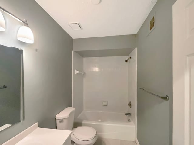 full bathroom with vanity, toilet, and tiled shower / bath combo