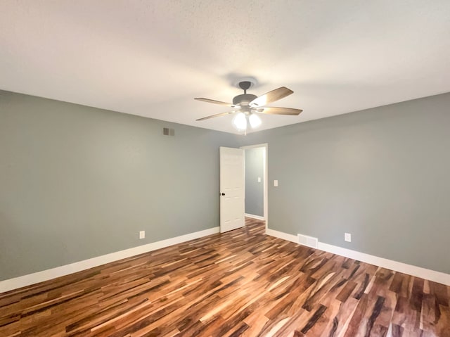 empty room featuring ceiling fan and wood-type flooring