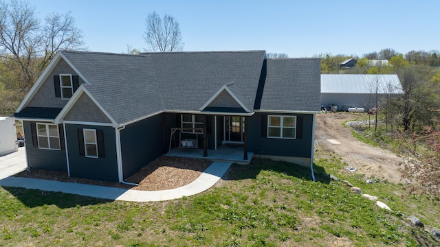 view of front facade with a front yard and a porch