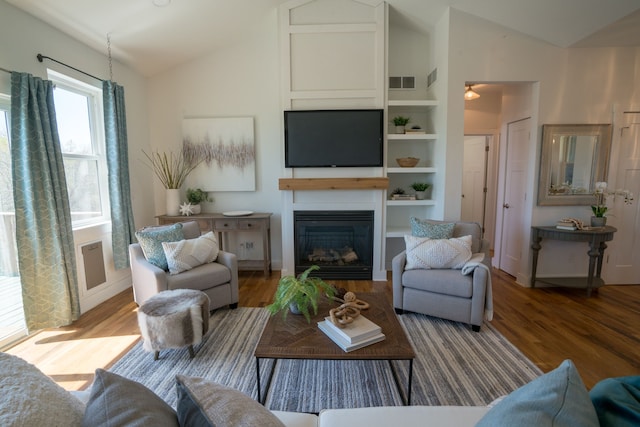 living room with hardwood / wood-style floors and lofted ceiling