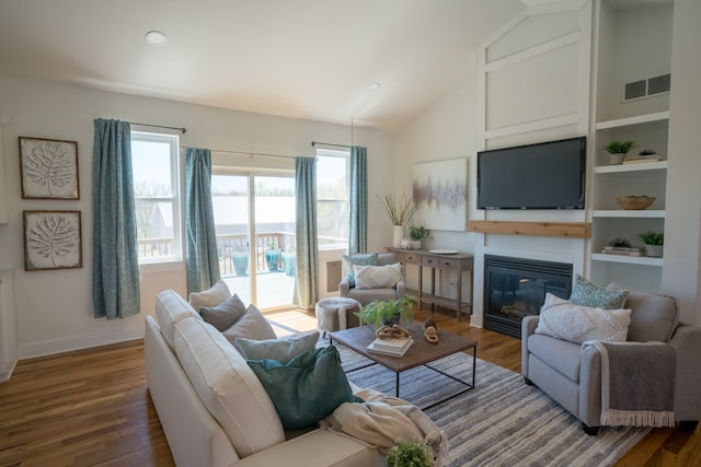 living room with hardwood / wood-style flooring and vaulted ceiling