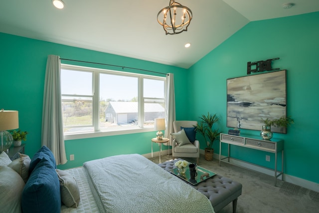 carpeted bedroom featuring a chandelier and vaulted ceiling